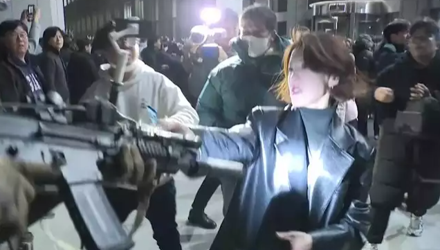 Ahn Gwi-ryeong is seen in this still image from video captured by JTBC grabbing an armed soldier's gun.